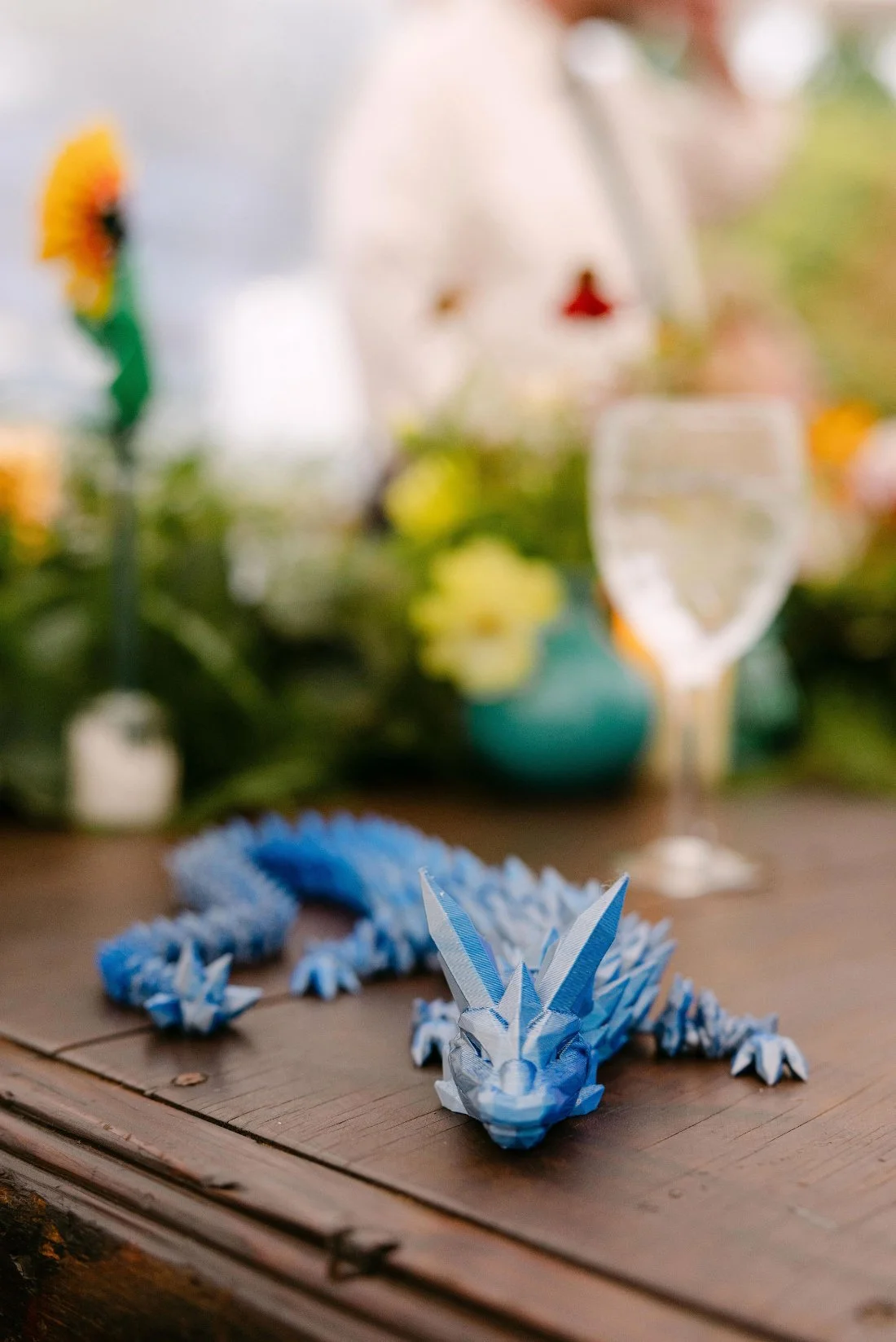 Custom blue dragon figurine as a playful table detail at an outdoor wedding in New York
