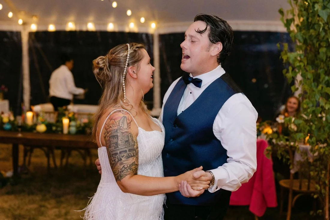 Bride and groom sharing a joyful dance at their outdoor wedding in New York