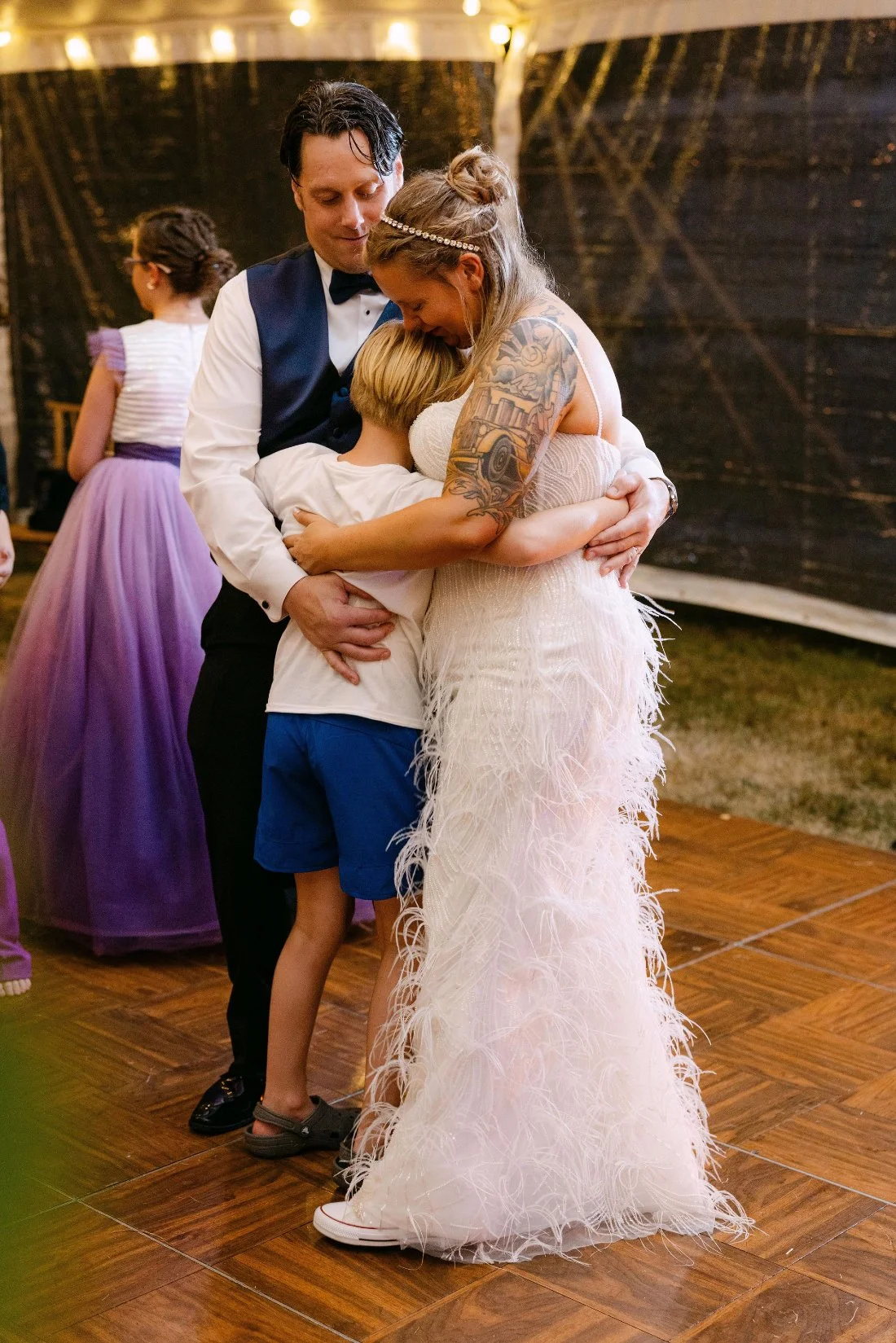 Bride warmly hugs a guest during the reception at an outdoor wedding in New York