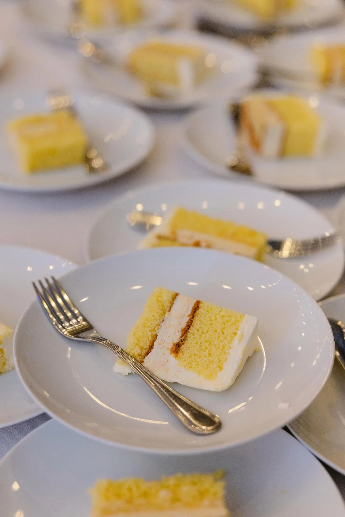 Wedding cake on display surrounded by floral accents at an outdoor wedding in New York