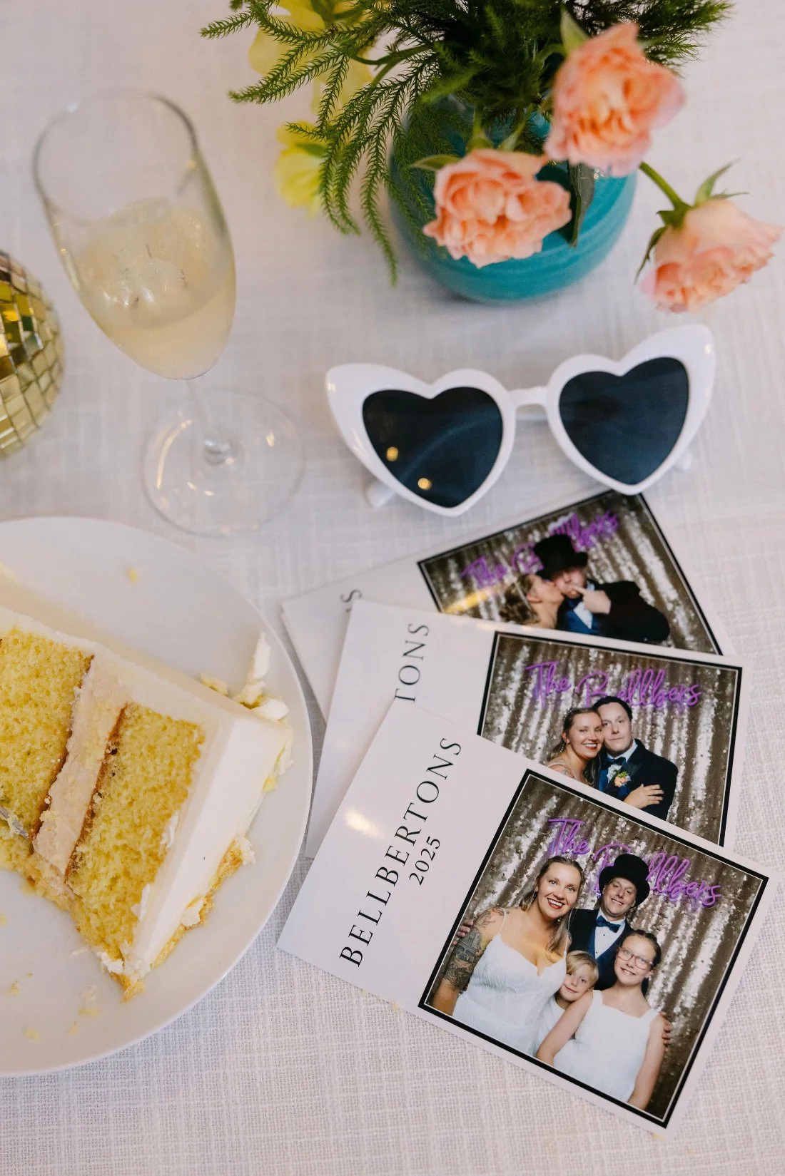 Printed Photo Booth pictures displayed on a table during an outdoor wedding in New York