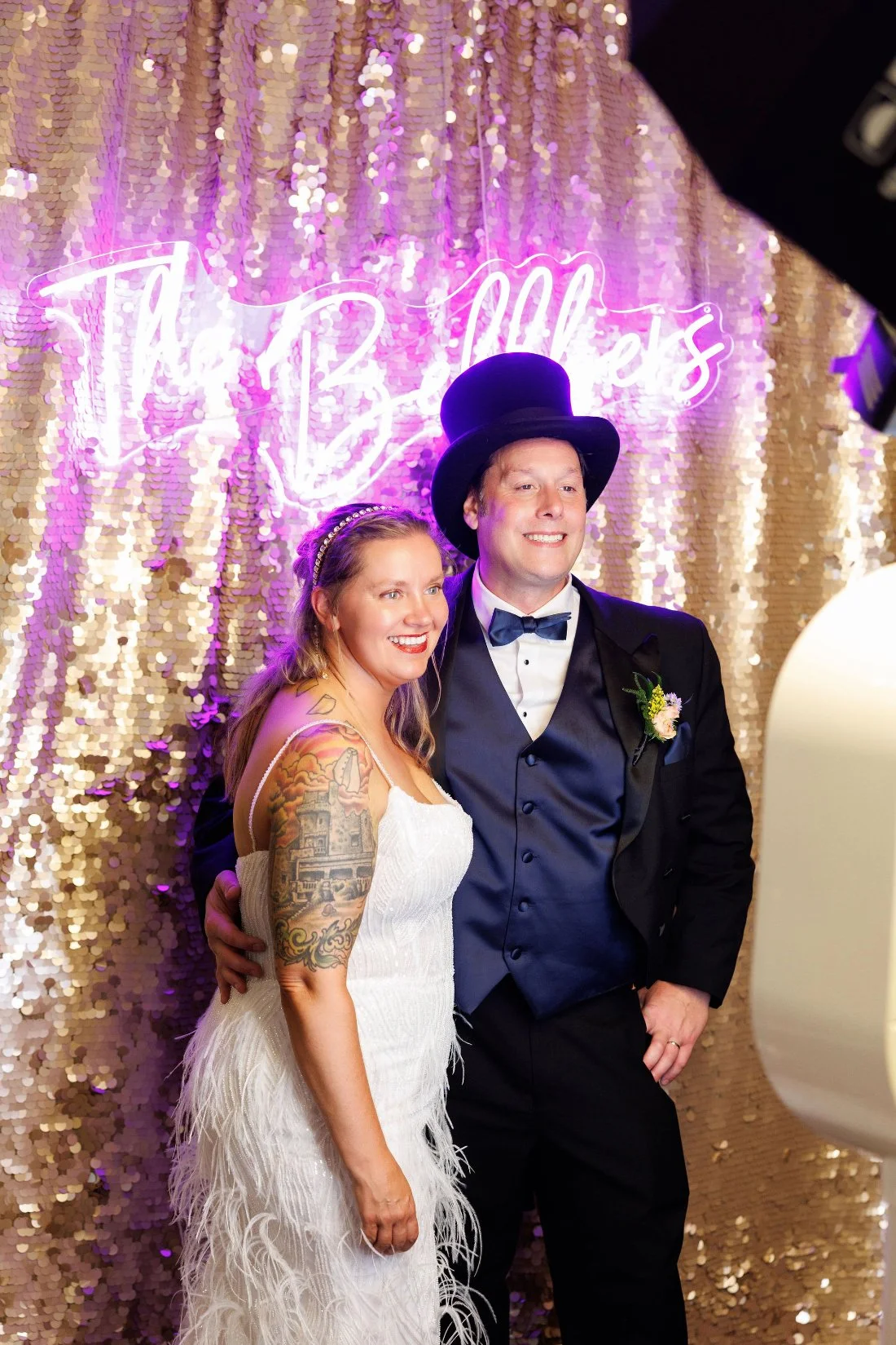 Bride and groom posing together in a playful Photo Booth at their outdoor wedding in New York