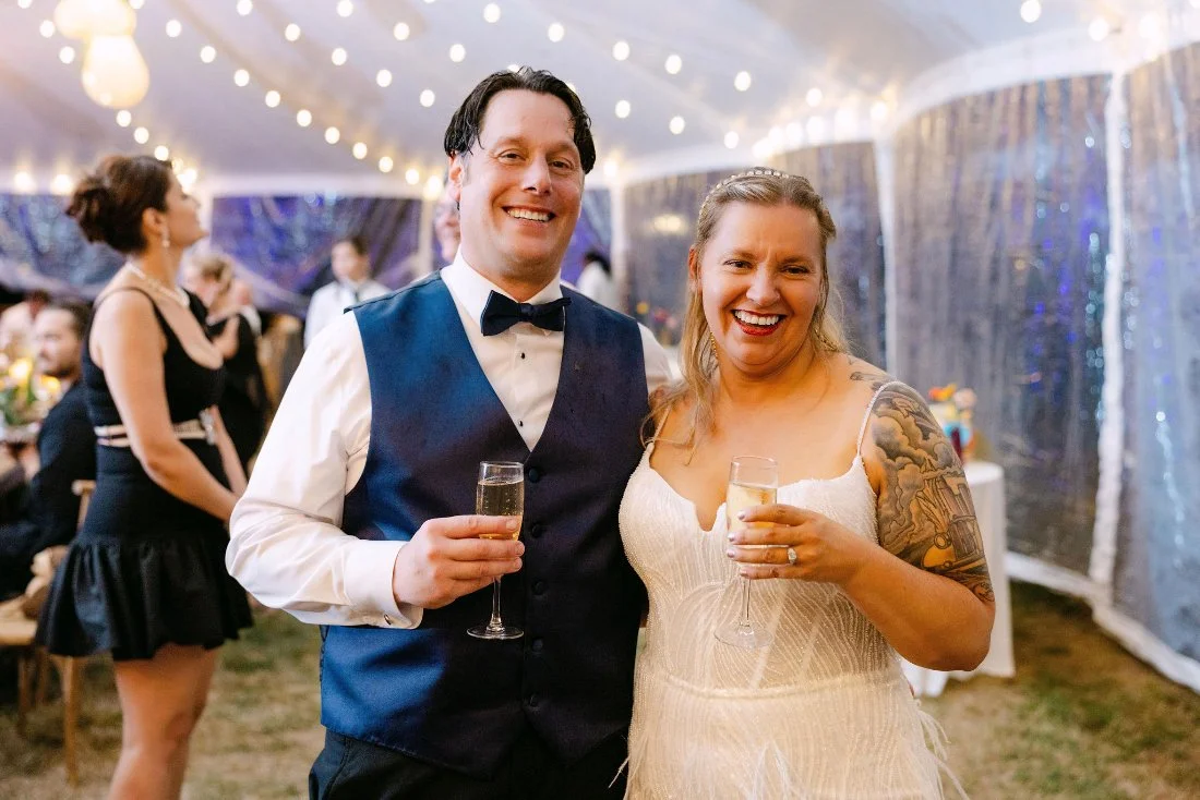 Newlyweds toasting with champagne at their outdoor wedding in New York