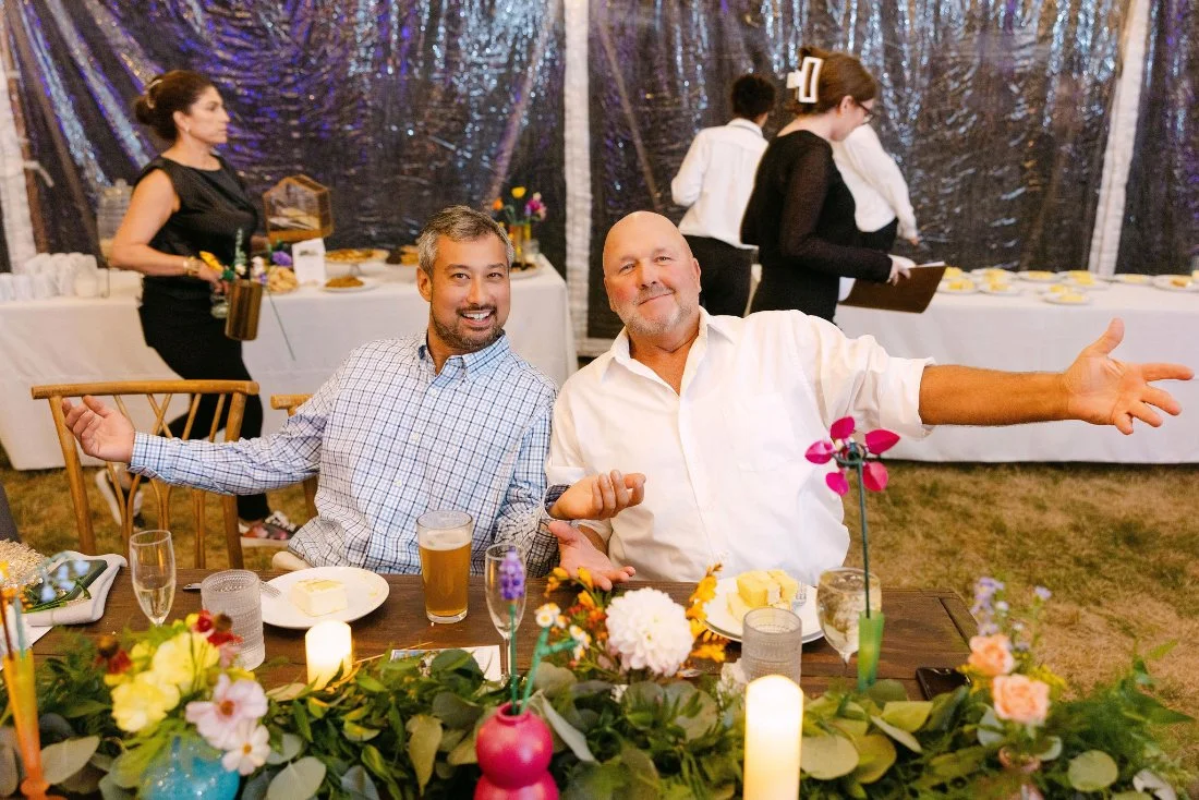 Wedding guests seated and smiling during the ceremony at an outdoor wedding in New York