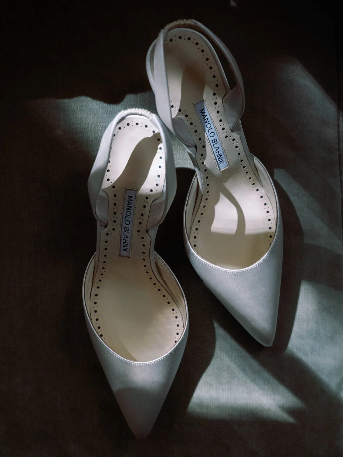Bride’s wedding shoes displayed in soft natural light inside the Water Mill home.