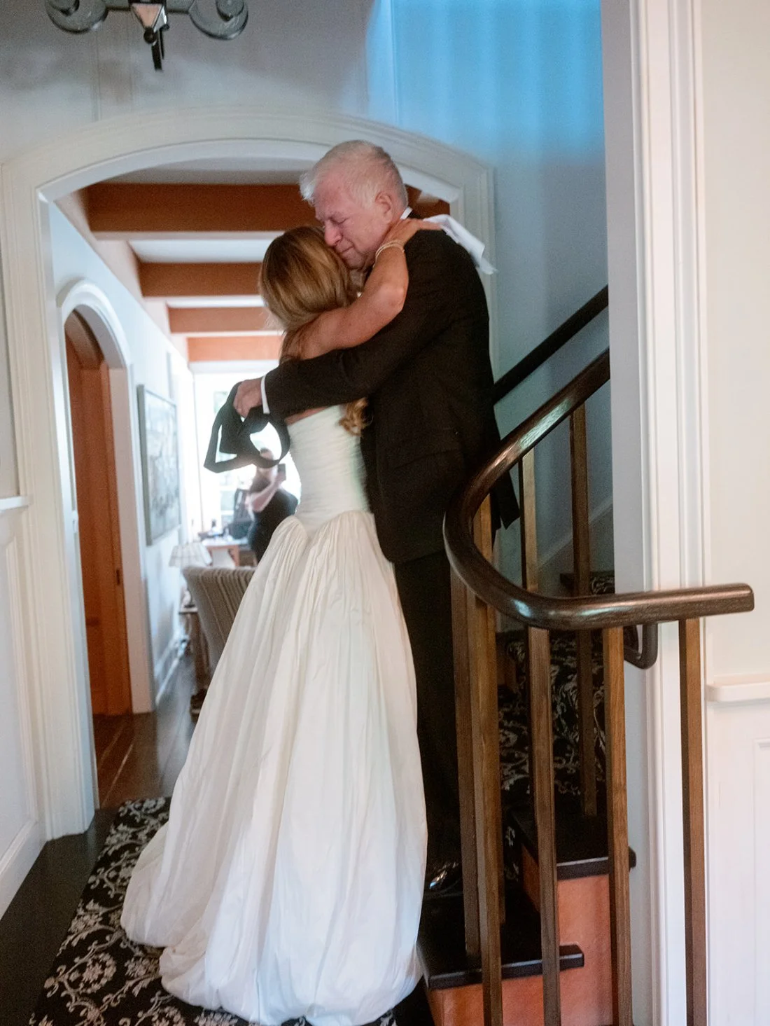Bride hugging her father on the staircase before the Hamptons wedding ceremony in Water Mill.