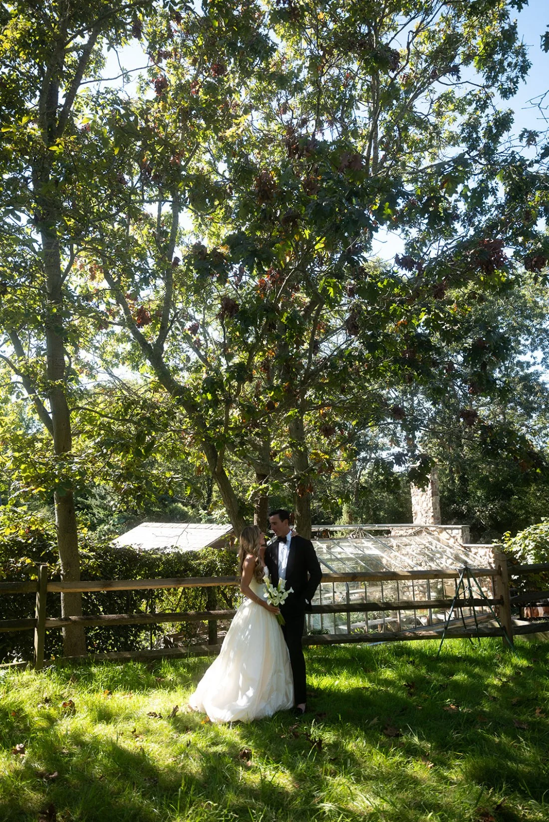 Bride and groom walking on their property during golden hour at their Hamptons wedding.