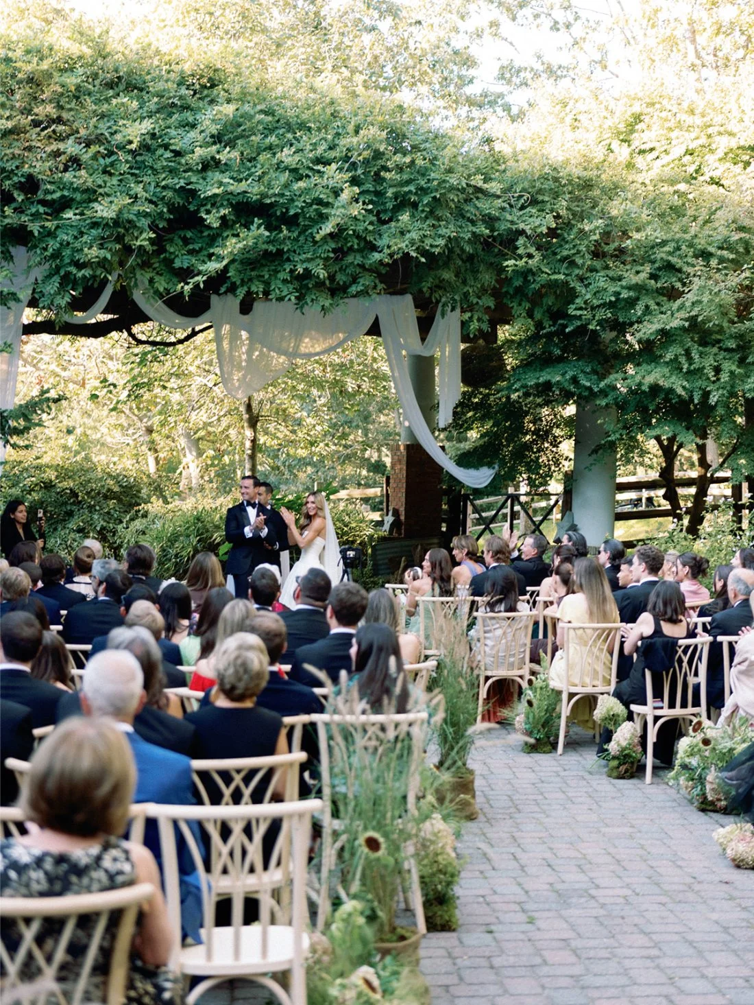 Wide ceremony view showing guests seated outdoors at a Hamptons wedding private estate.