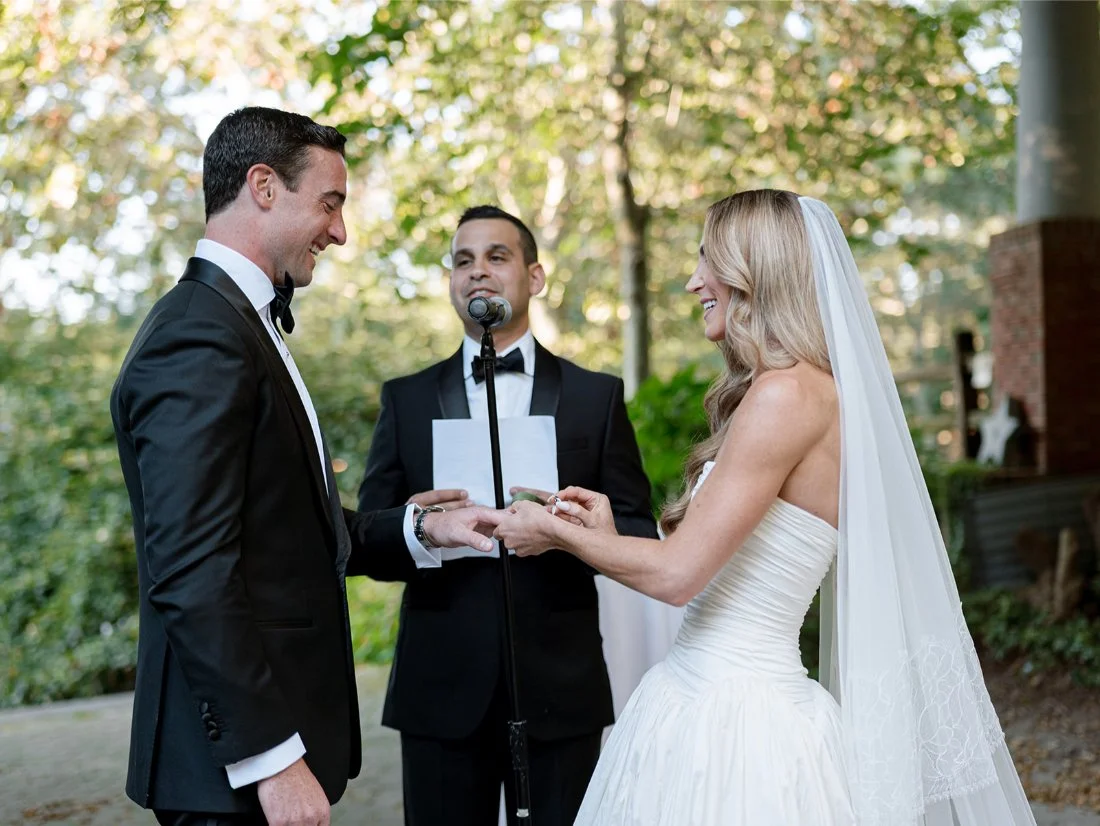 Bride and groom standing together at the altar during their outdoor Water Mill ceremony.