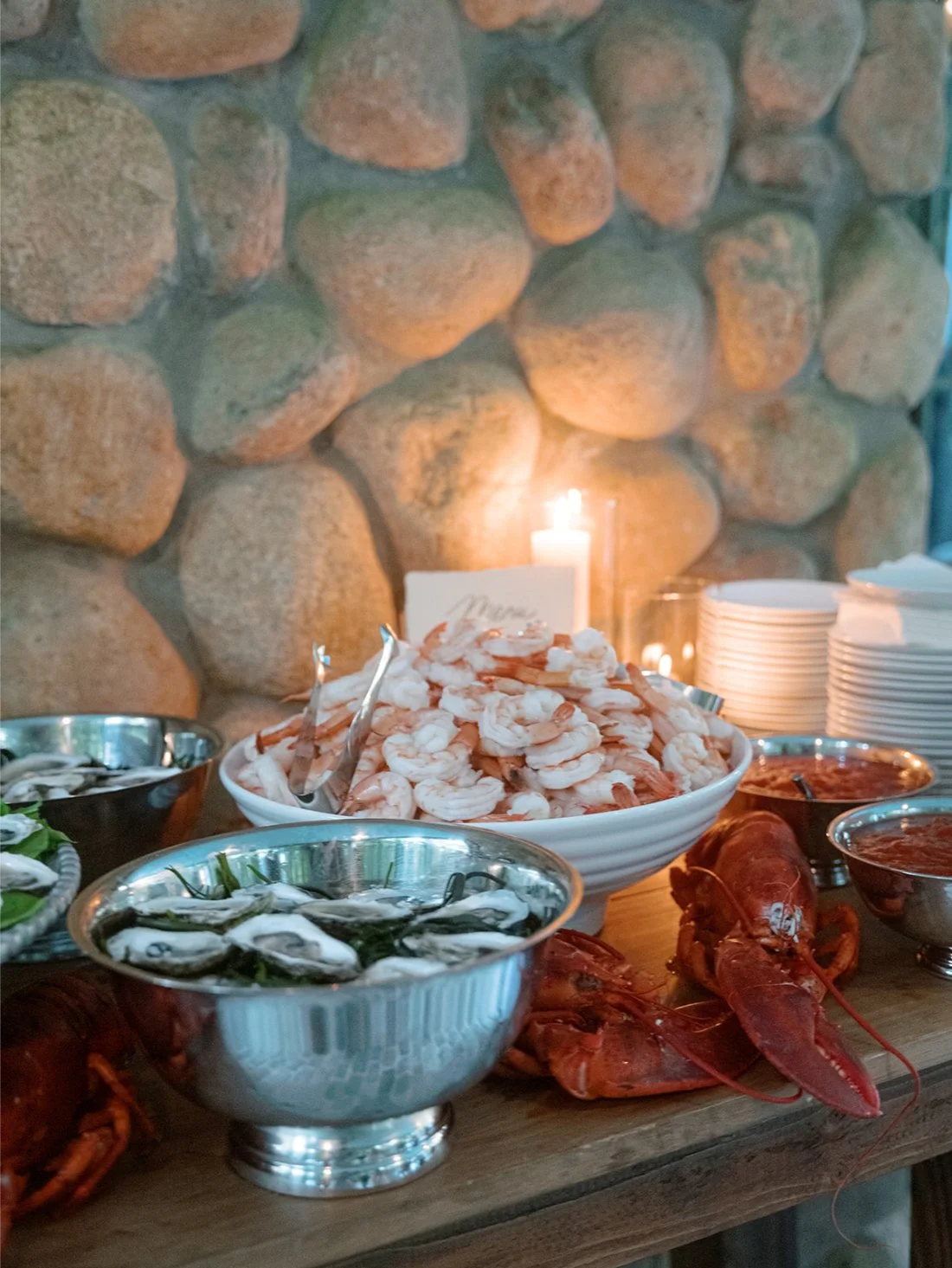 Raw bar food display with oysters and shrimp at an elegant Hamptons wedding reception.