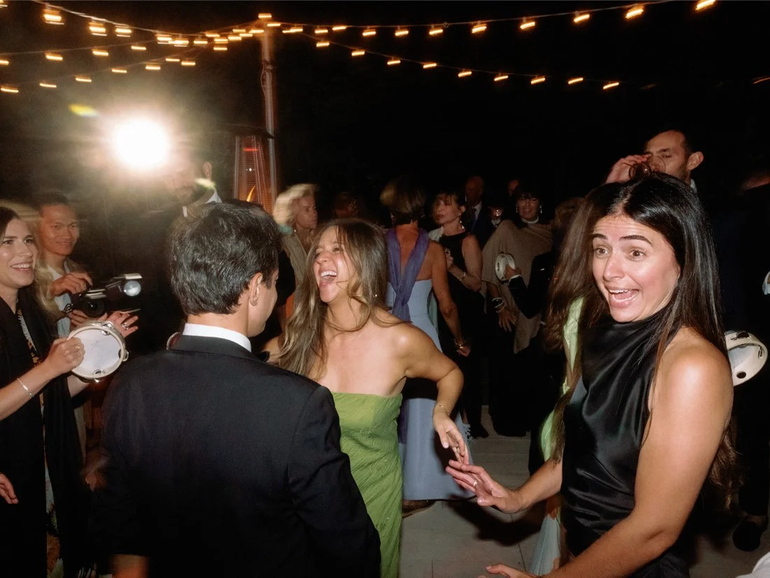 Friends dancing and celebrating under the lights at a lively Hamptons wedding reception.