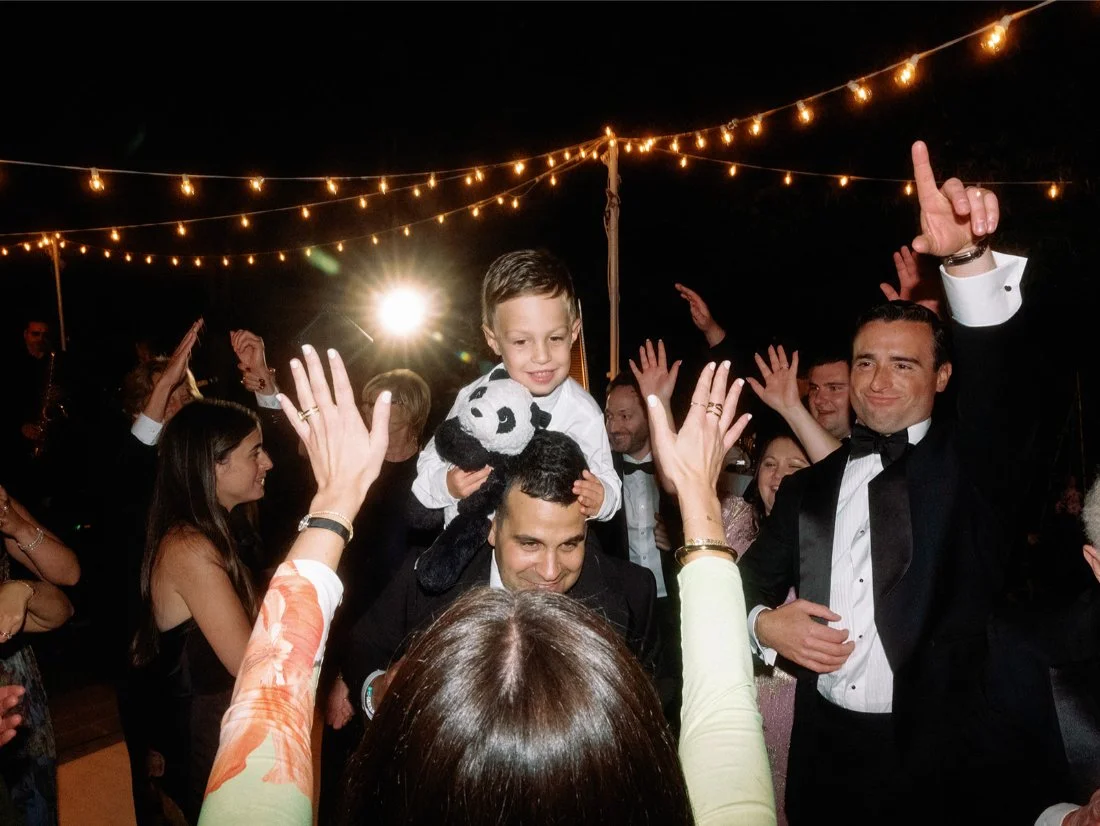 Guests partying and dancing outside the private residence during the Hamptons wedding celebration.