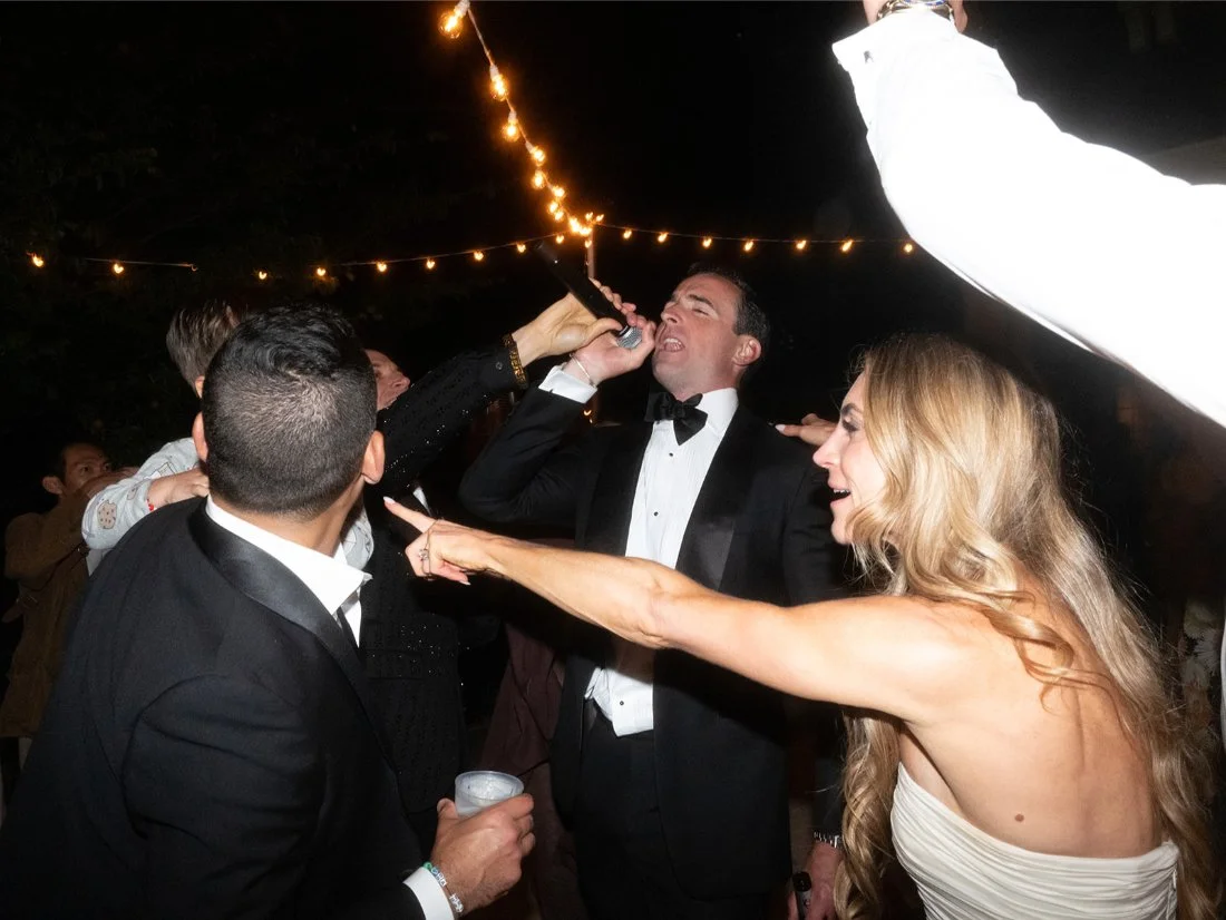 Guests partying and dancing outside the private residence during the Hamptons wedding celebration.