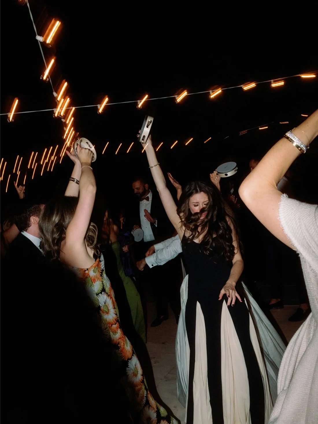 Guests partying and dancing outside the private residence during the Hamptons wedding celebration.