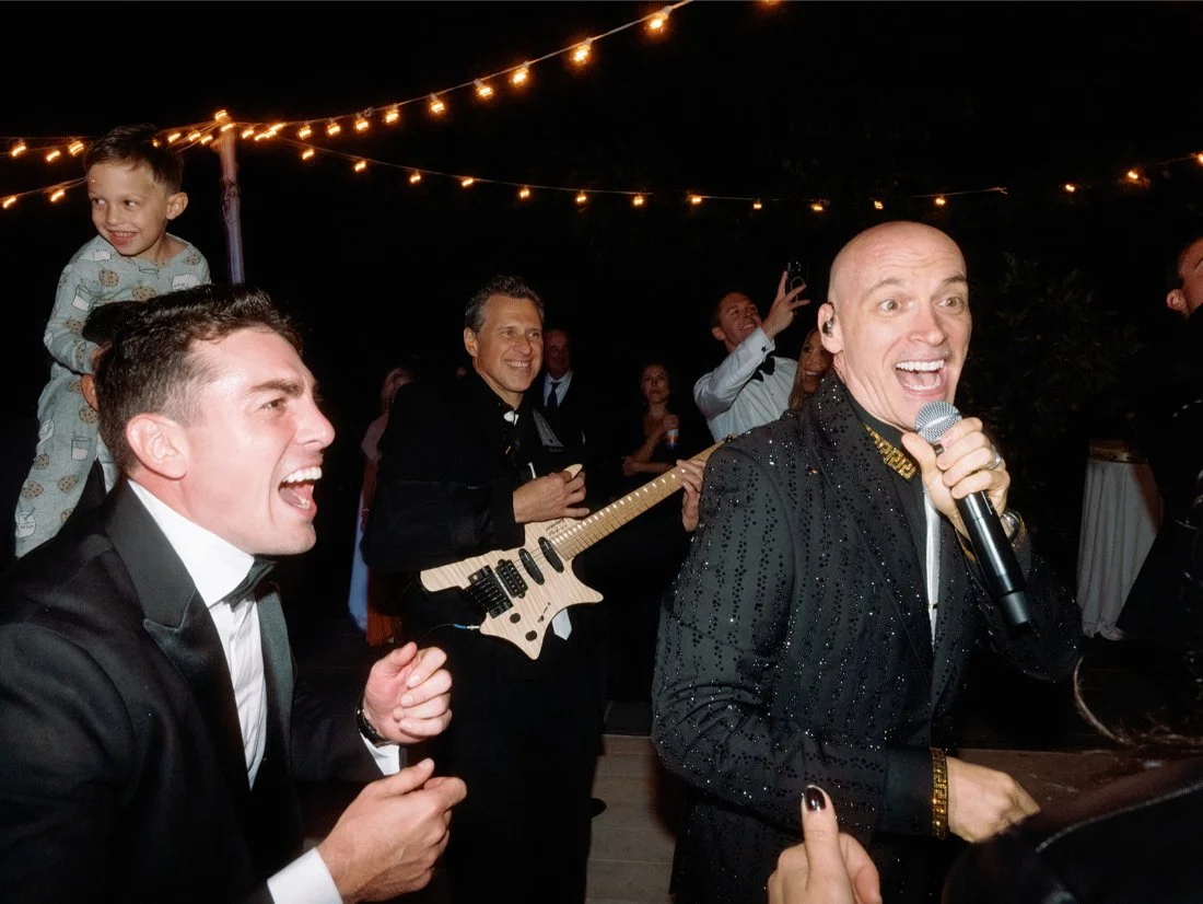 Guests singing along as the live band plays during the Hamptons wedding reception.