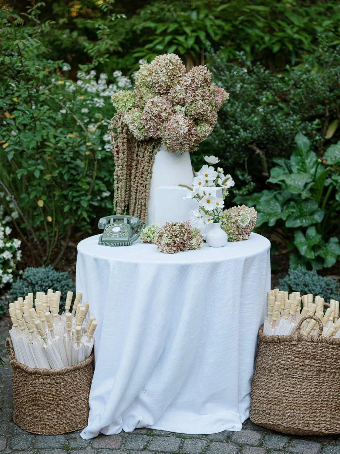 Floral detail display with hydrangeas and a vintage green phone for voicemail messages at a Hamptons wedding.