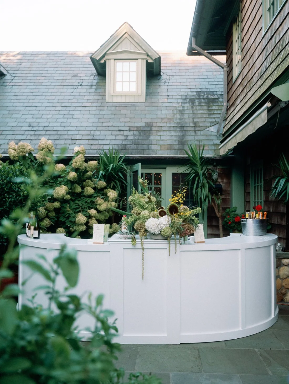 Curved white bar installed outside the private estate for a Hamptons wedding reception.