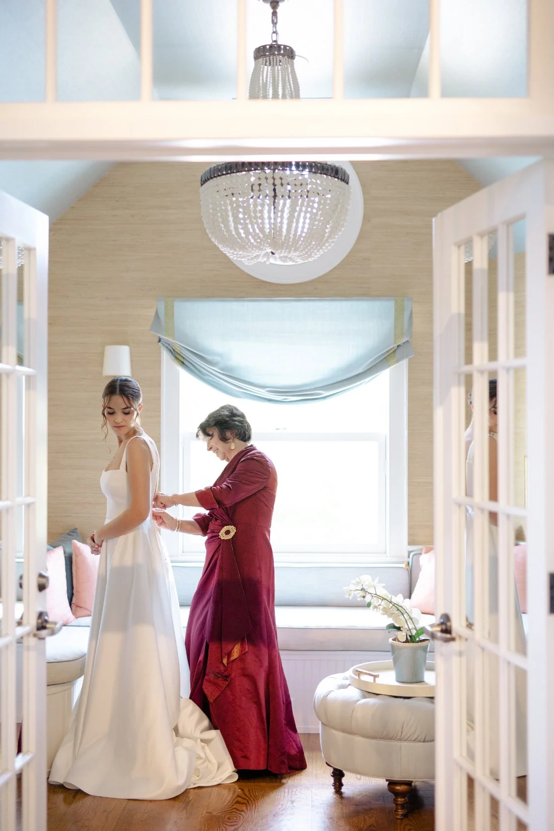 Bride getting ready with mother in elegant coastal suite at Peconic Bay Yacht Club
