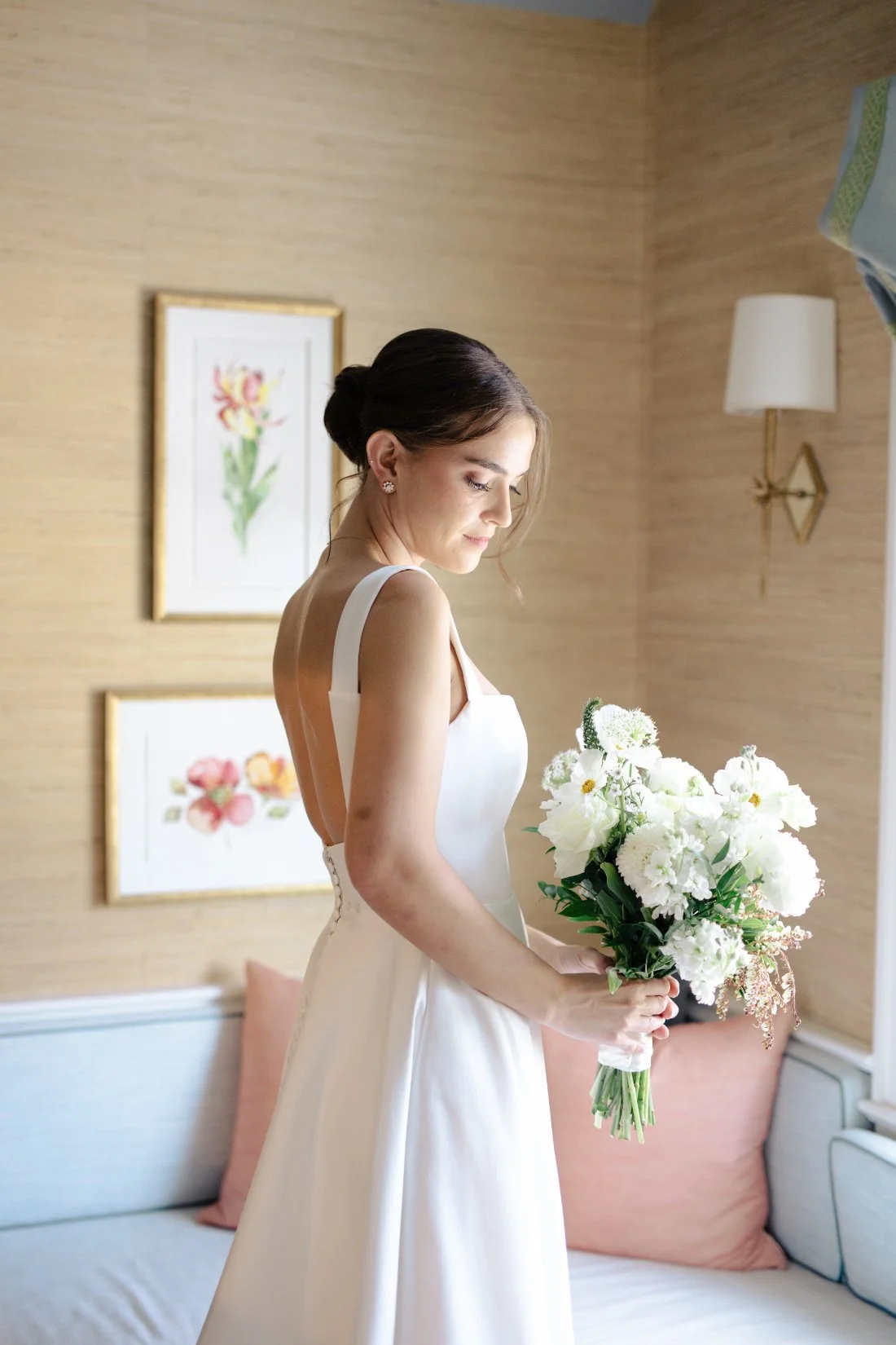 Bride holding white bouquet in soft natural light before Peconic Bay Yacht Club wedding