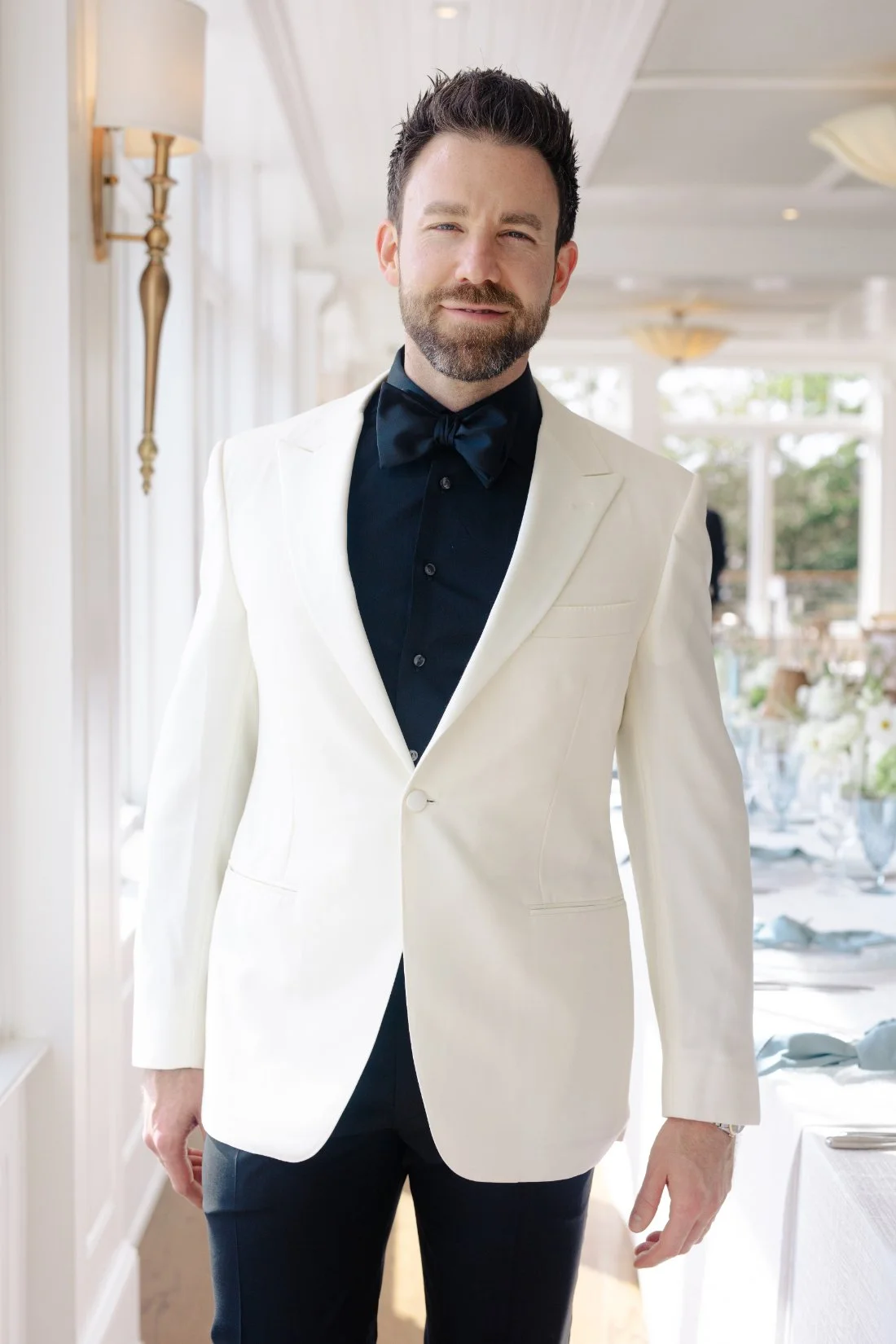 Groom portrait in white jacket during Peconic Bay Yacht Club wedding reception space