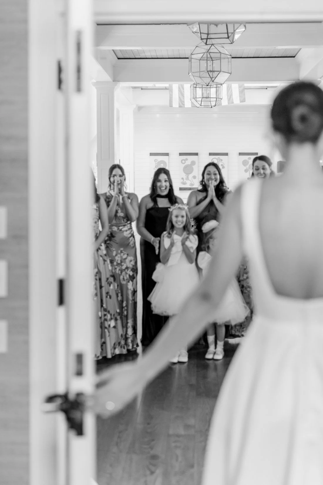 Emotional bridesmaids first look reaction to bride in wedding dress
