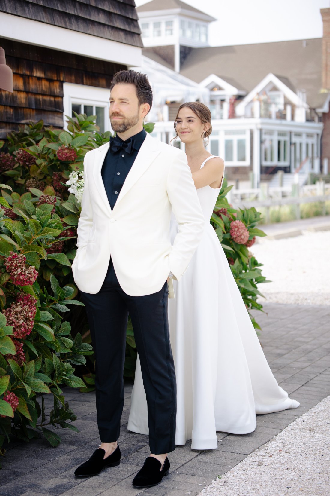 Bride tapping groom for first look outside Peconic Bay Yacht Club in Southold New York