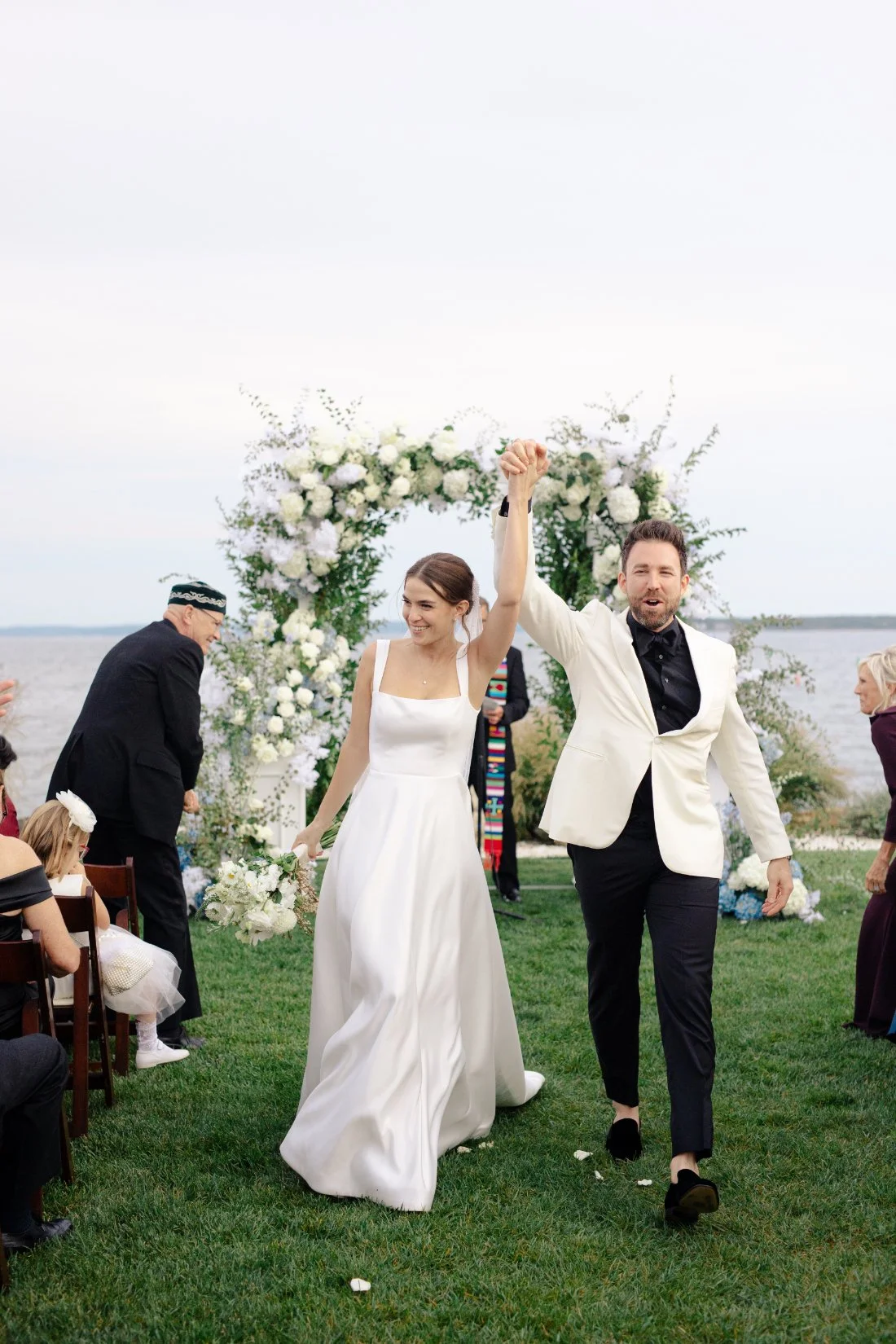 Bride and groom celebrating down the aisle after ceremony at Peconic Bay Yacht Club
