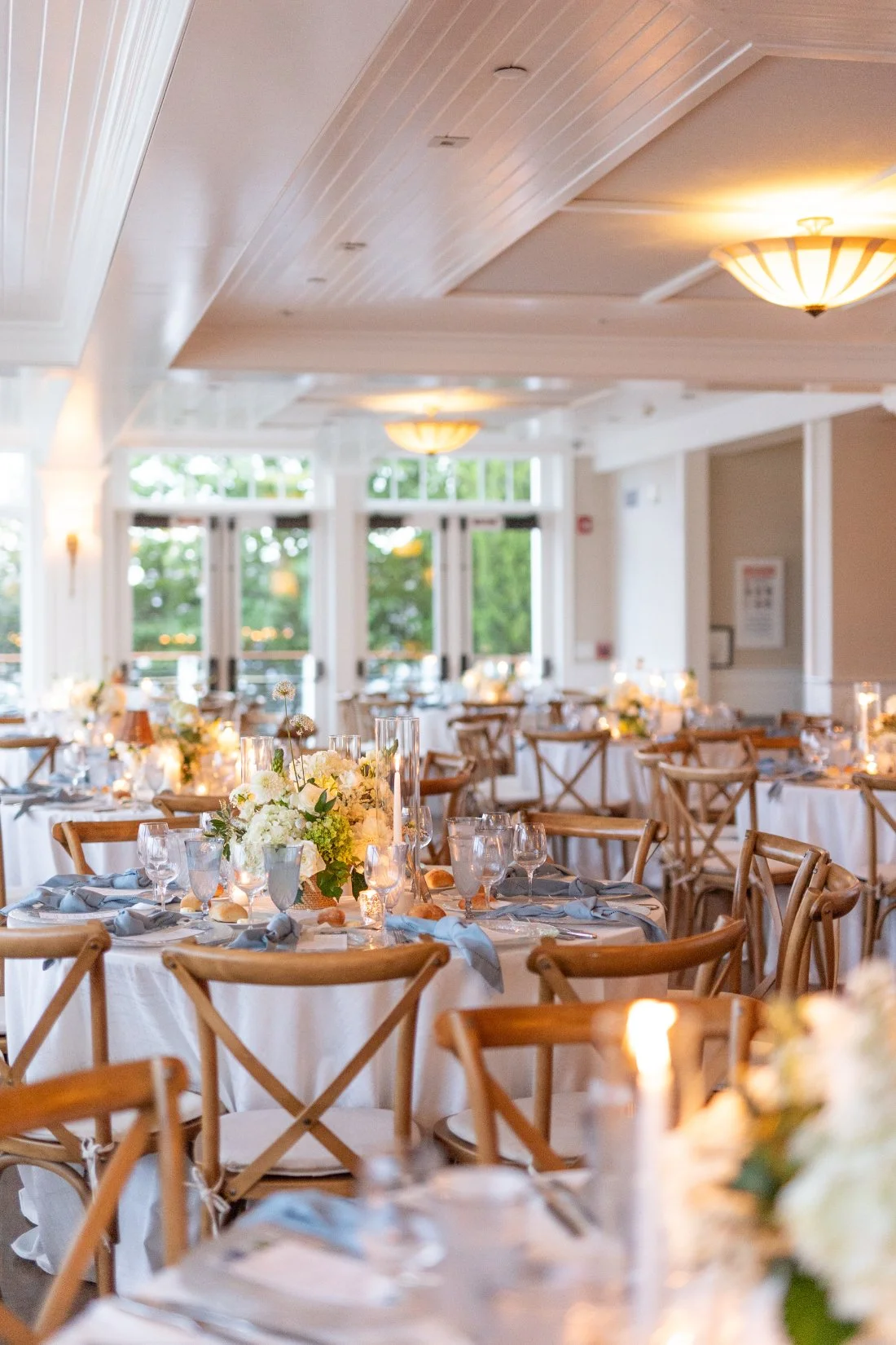 Elegant reception tablescape with candles and blue napkins at Peconic Bay Yacht Club