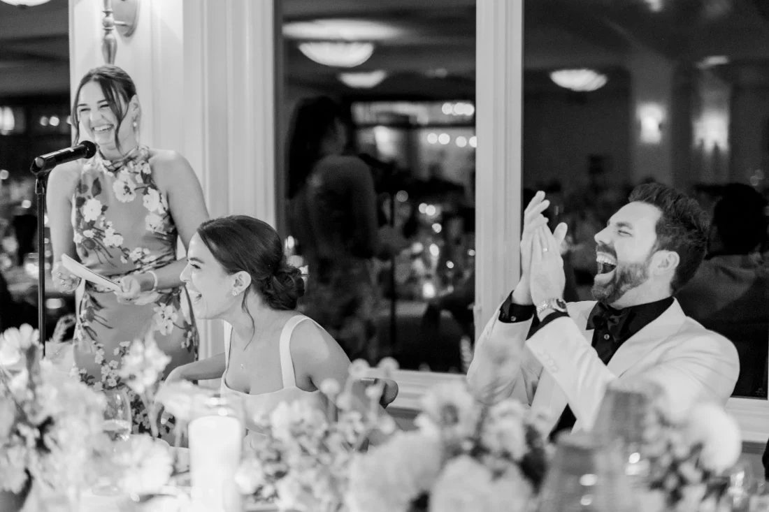 Bride and groom laughing during heartfelt wedding speeches at Peconic Bay Yacht Club