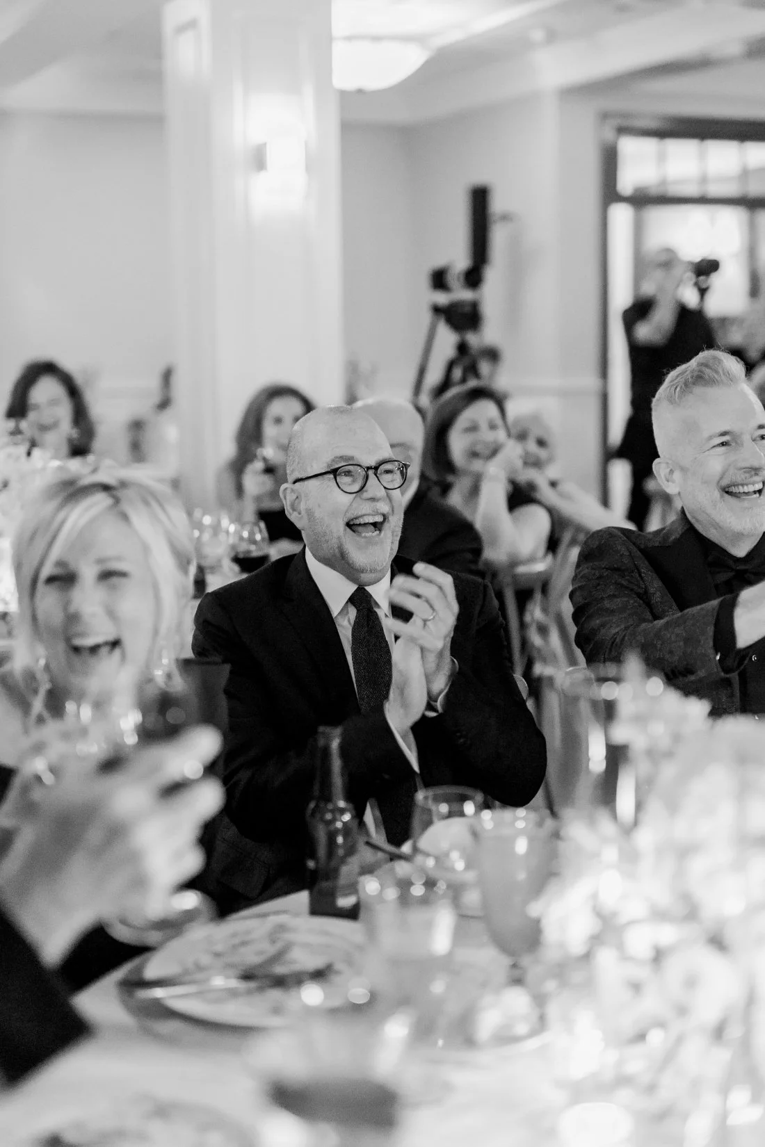 Guests laughing and applauding during reception speeches at Peconic Bay Yacht Club