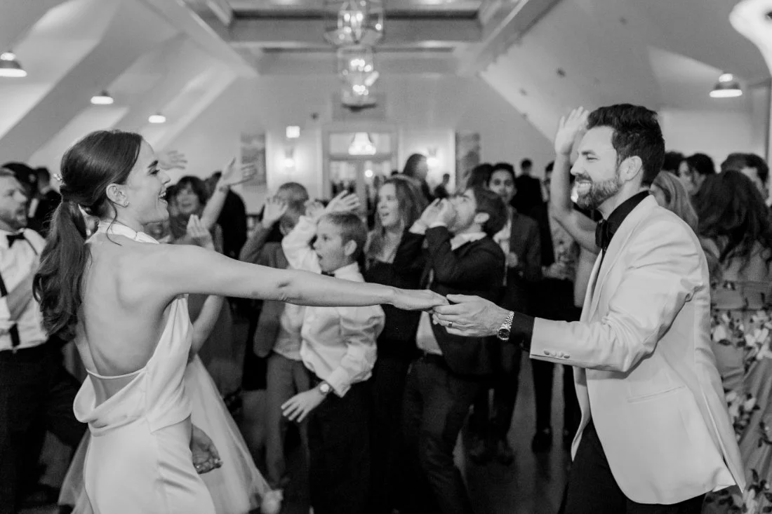 Bride and groom holding hands while dancing at Peconic Bay Yacht Club wedding