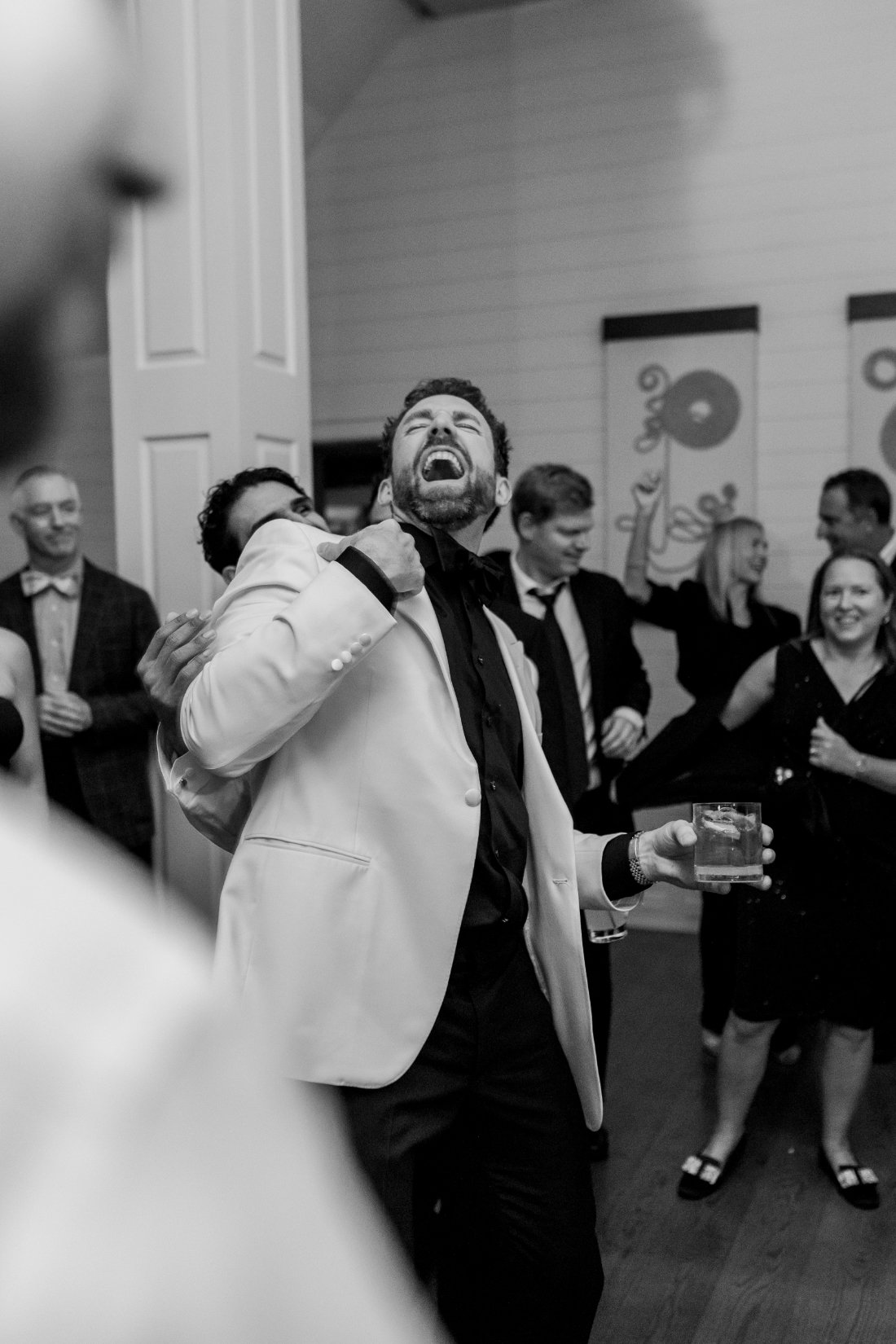 Groom laughing and dancing on the dance floor at Peconic Bay Yacht Club