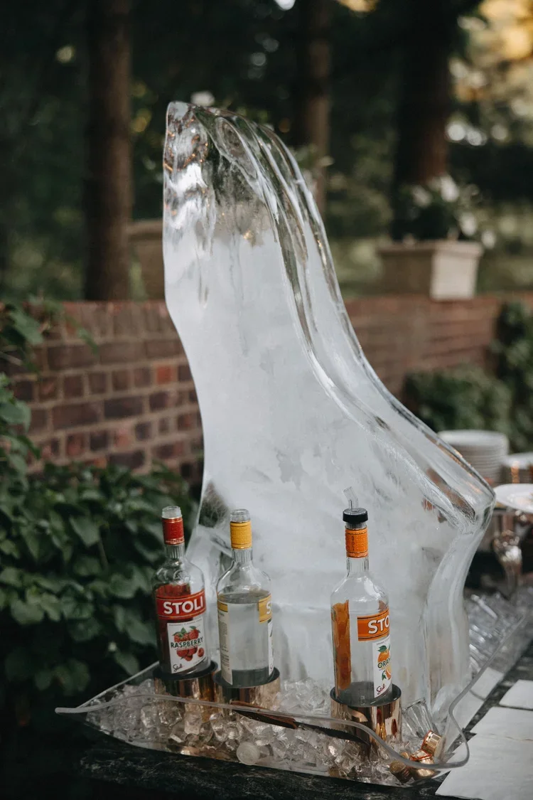 Ice sculpture bar display with chilled bottles adding a unique touch to the wedding guest experience