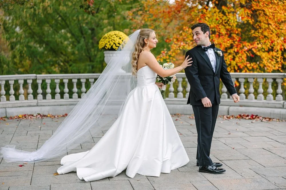 Bride tapping groom for first look on terrace at a Tarrytown House Estate wedding