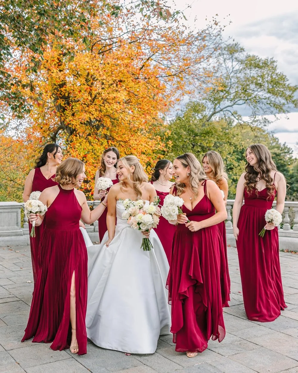 Bride with bridesmaids in burgundy dresses at a Tarrytown House Estate wedding in autumn