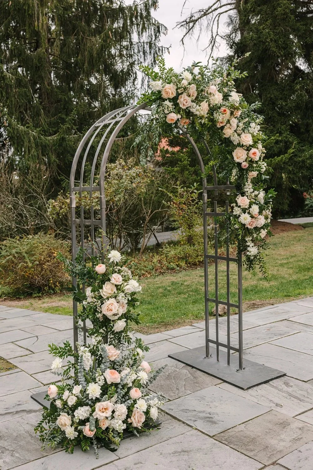 Floral ceremony arch with soft blush and white blooms at Tarrytown NY outdoor wedding