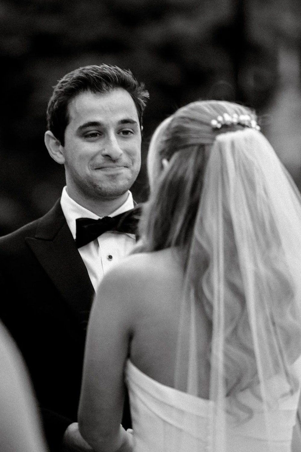 Bride and groom holding hands during emotional vows at Tarrytown NY outdoor wedding