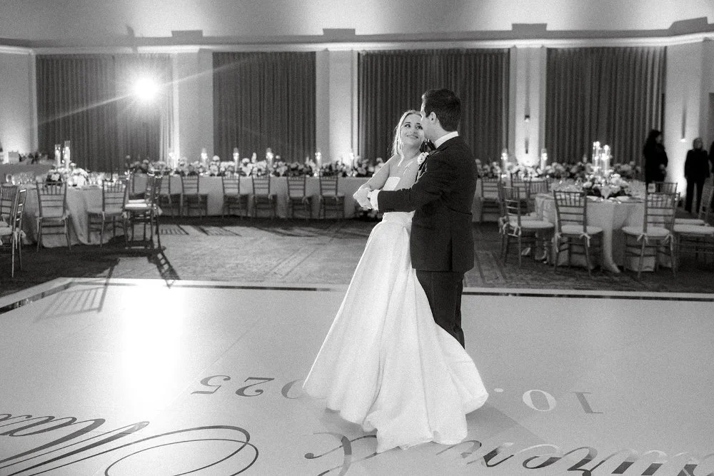 Bride and groom sharing their first dance in candlelit ballroom