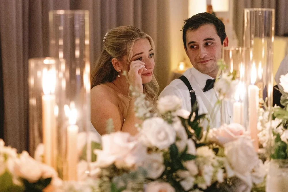 Bride wiping away tears during heartfelt reception moment at Tarrytown NY outdoor wedding