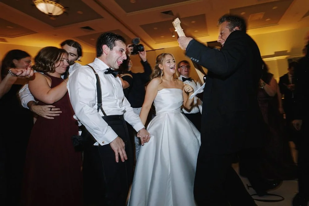 Guests dancing and celebrating with couple during high-energy reception