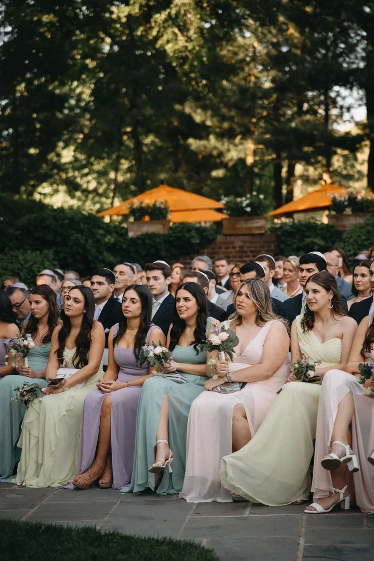 Guests seated during an intimate outdoor ceremony, illustrating thoughtful wedding ceremony ideas that enhance the guest experience.