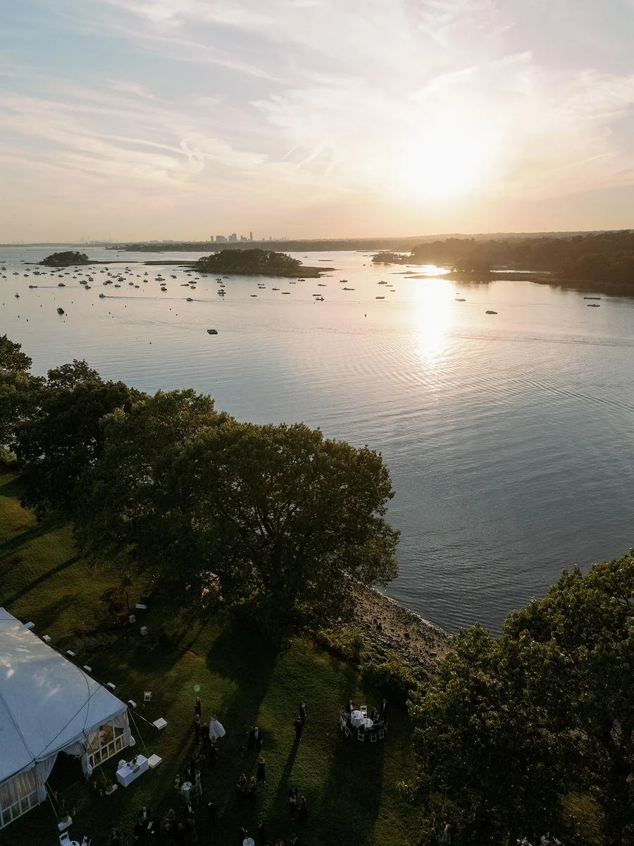 Golden hour views over the Long Island Sound from the grounds of Wainwright House during a fall wedding weekend in Rye, New York.