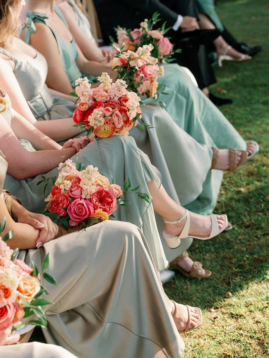 close up of bridesmaids dresses and floral designs
