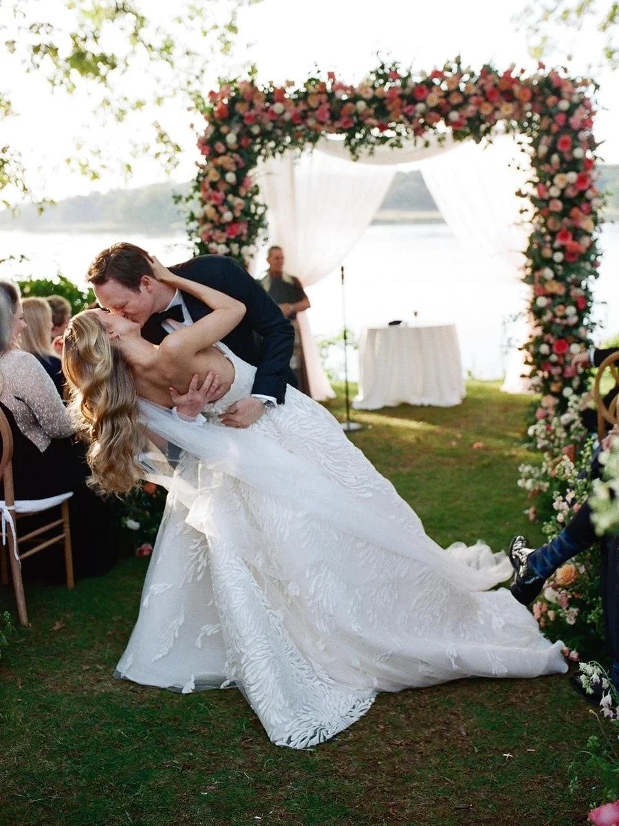 bride and groom kiss at the end of the aisle after their wedding ceremony 