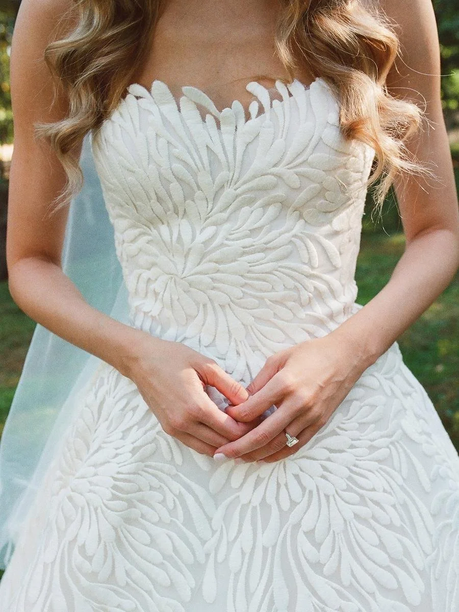 Close-up of a textured wedding gown, cathedral veil, and white calla lily bouquet at a Wainwright House wedding.