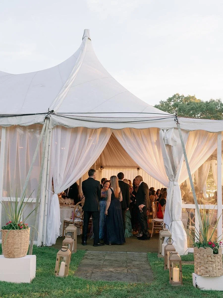 Guests gathering outside the reception tent entrance before the evening celebration at a Wainwright House wedding.