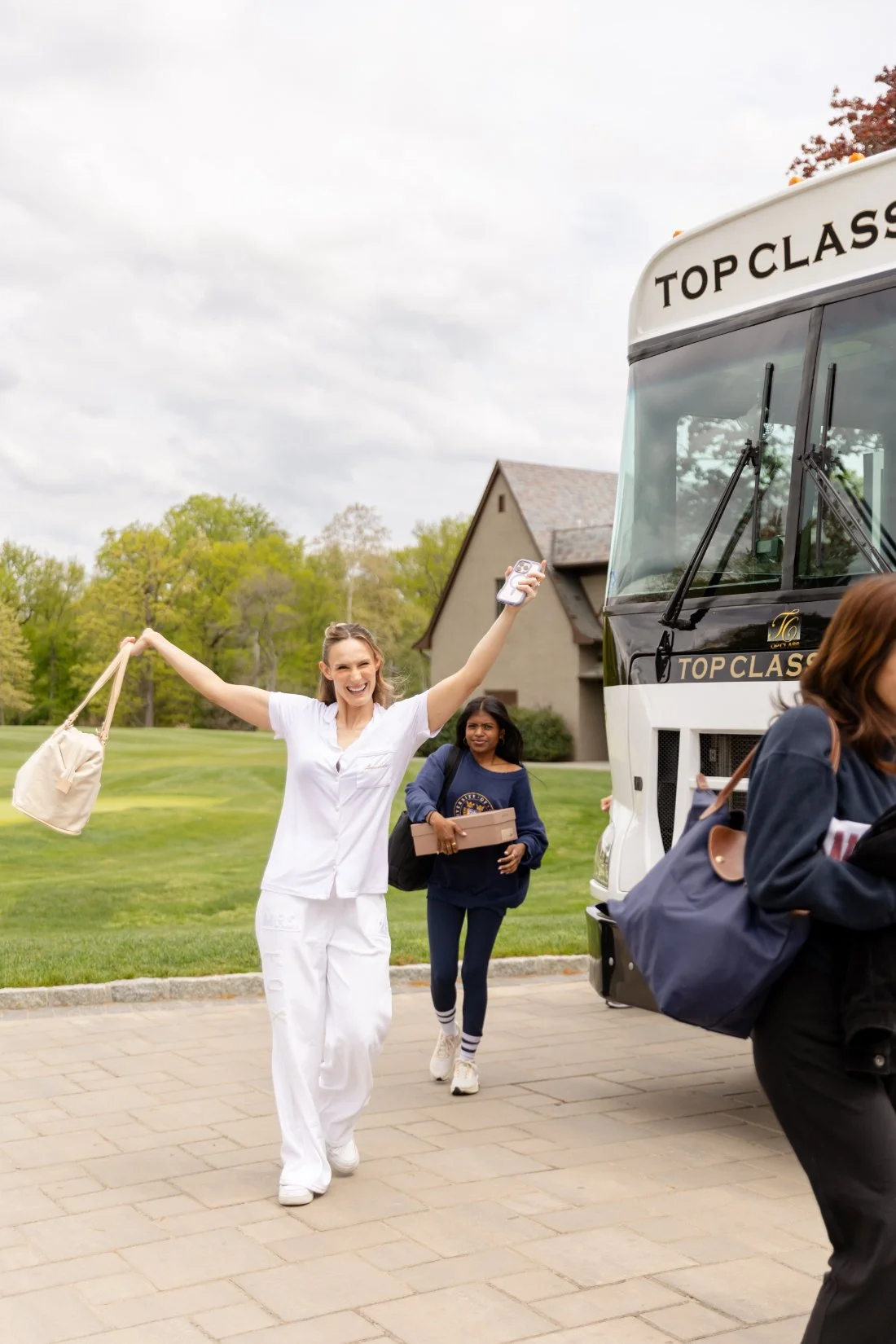 Bride arriving with her wedding party for her Quaker Ridge Golf Club wedding