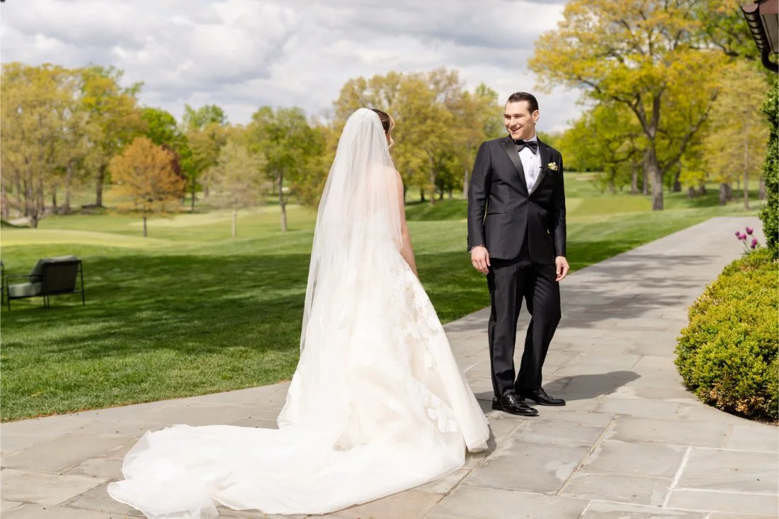 Groom turns to see his bride during their Quaker Ridge Golf Club wedding first look
