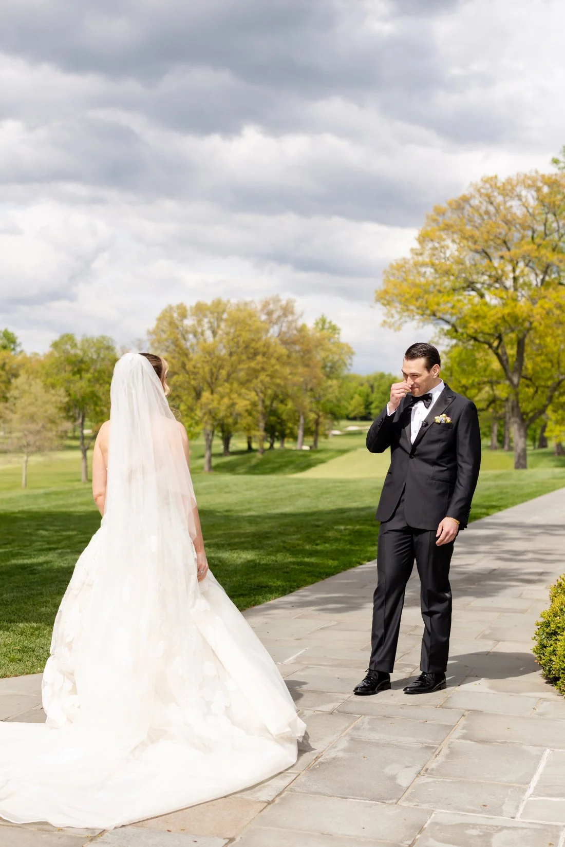 Emotional groom reacts to seeing his bride during their outdoor first look
