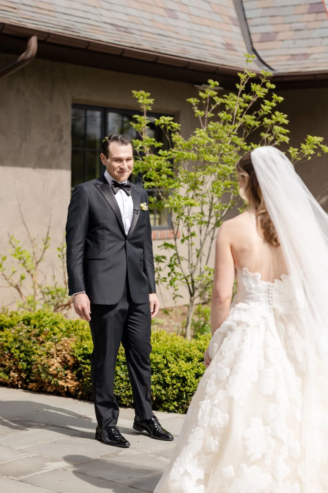 Groom smiles at his bride during a Quaker Ridge Golf Club wedding first look